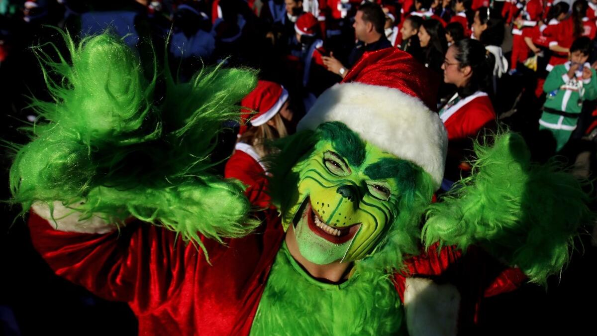 A participant dressed as the Green Goblin in Santa Claus costume participate in the "Run Santa Run Guadalajara" annual Christmas race, in Guadalajara, Mexico, on December 8, 2019. Ulises RUIZ / AFP