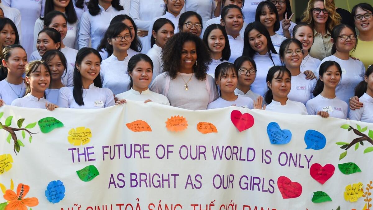 Former US First Lady Michelle Obama (C) poses for picture with Vietnamese students in Can Giuoc district, Long An province on December 9, 2019. Michelle Obama and Julia Roberts visit to promote girls' education in Vietnam. Nhac NGUYEN / AFP