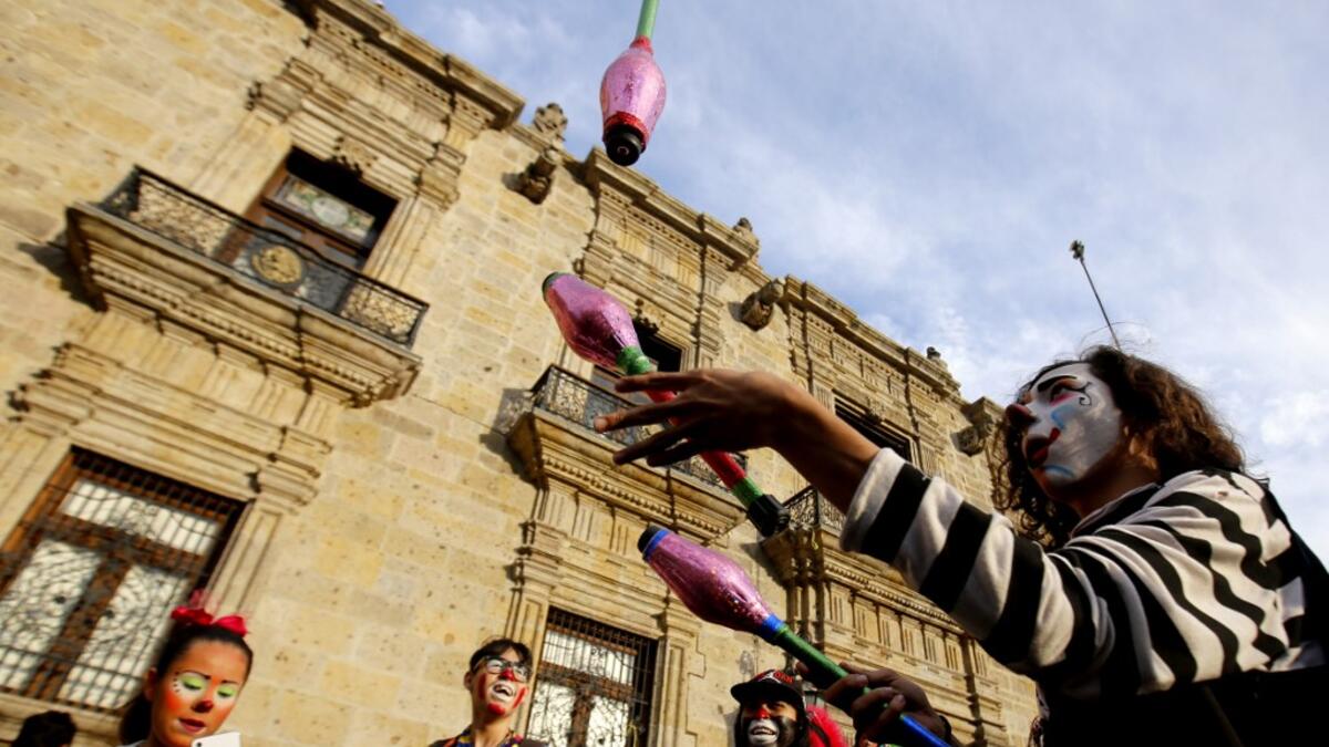 A group of clowns play during the International Clown Day in Guadalajara, Mexico, on December 10, 2019. Ulises Ruiz / AFP