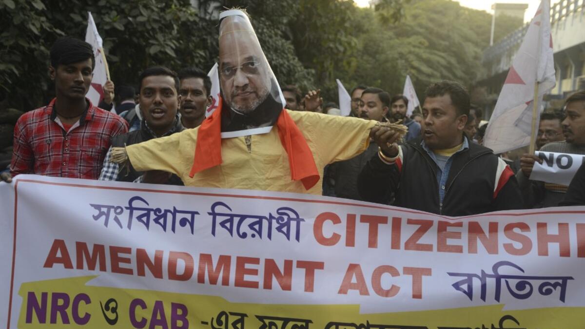 Indian left wing activists of Democratic Youth Federation of India (DYFI) shout slogans as they burn an effigy of India's Home Minister Amit Shah during a demonstration against the Indian government's Citizenship Amendment Bill in Siliguri on December 14, 2019. SILIGURI, INDIA