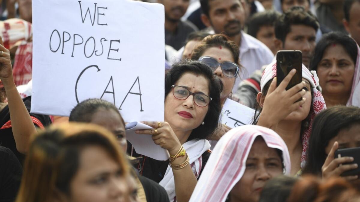 Demonstrators take part in a musical concert to protest against the Indian government's Citizenship Amendment Bill (CAB) in Guwahati on December 15, 2019. Some 5,000 people took part in a fresh demonstration in Guwahati on December 15, with hundreds of police watching on as they sang, chanted and carried banners with the words "long live Assam". Sajjad HUSSAIN / AFP