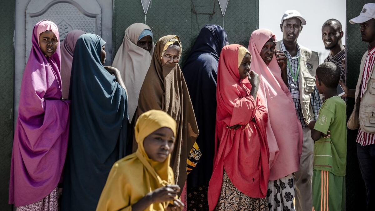 A group of displaced women, due to intense flooding, queue at the entrance of a distribution center waiting for sanitary pads at a displacement camp in Beledweyne, Somalia, on December 14, 2019. The rains have inundated big areas surrounding Beledweyne area forcing thousands of people to leave their houses and look for humanitarian assistance while living in displacement camps. Due to climate change and human activities, cycles of floods and droughts have become more recurrent and completely unpredictable i