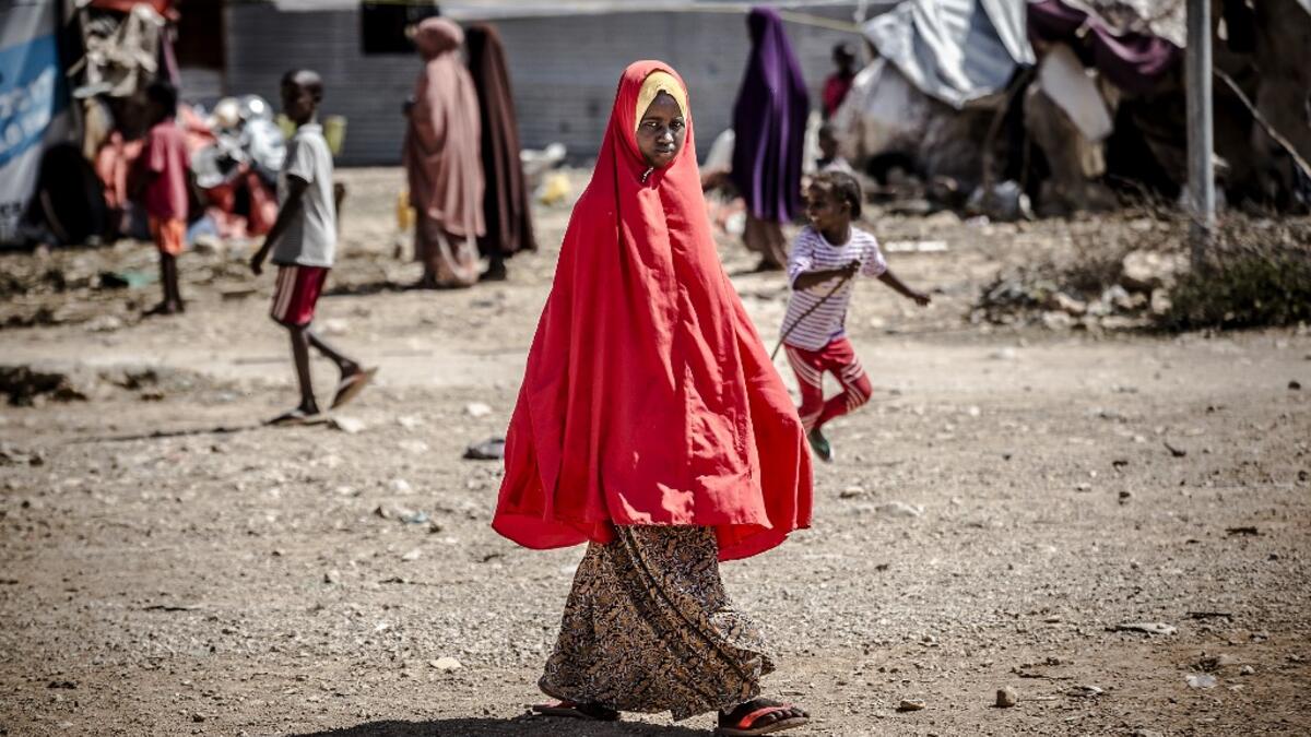 A girl walks towards her tent at a displacement camp for people affected by intense flooding in Beledweyne, Somalia, on December 14, 2019. The rains have inundated big areas surrounding Beledweyne area forcing thousands of people to leave their houses and look for humanitarian assistance while living in displacement camps. Due to climate change and human activities, cycles of floods and droughts have become more recurrent and completely unpredictable in Somalia exposing hundreds of thousands of people every