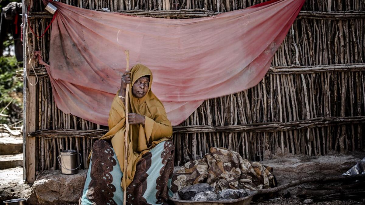 A displaced woman sits under the shadow at the place where she sleeps at a displacement camp in Beledweyne, Somalia, on December 14, 2019. The rains have inundated big areas surrounding Beledweyne area forcing thousands of people to leave their houses and look for humanitarian assistance while living in displacement camps. Due to climate change and human activities, cycles of floods and droughts have become more recurrent and completely unpredictable in Somalia exposing hundreds of thousands of people every