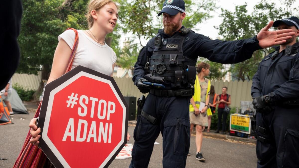 Police disperse demonstrators during a climate protest in Sydney on December 19, 2019. Protesters marched on Australian Prime Minister Scott Morrison's official residence in Sydney to demand curbs on greenhouse gas emissions and highlight his absence on an overseas holiday as bushfires burned across the region. Wendell TEODORO / AFP