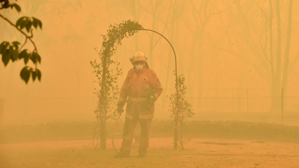 A fireman fights a bushfire to protect a property in Balmoral, 150 kilometres southwest of Sydney on December 19, 2019. A state of emergency was declared in Australia's most populated region on December 19, as a record heat wave fanned unprecedented bushfires. PETER PARKS / AFP