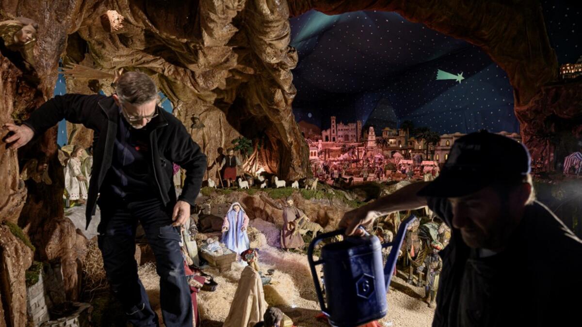 Volunteers set nativity figures at the 43rd edition of the "Presepio of Cavallermaggiore", a 300sqm Christmas Nativity crib in the Oratorio San Michele on December 20, 2019 in Cavallermaggiore, near Cuneo, Northwestern Italy. The "Presepio" is made by ten volunteers who every year spend 3 months to build a new edition with hundred of figures. MARCO BERTORELLO / AFP