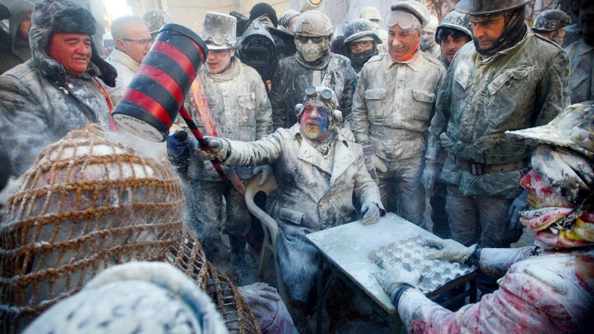 Revellers dressed in mock military garb take part in the "Els Enfarinats" battle in the southeastern Spanish town of Ibi on December 28, 2019. During this 200-year-old traditional festival participants known as Els Enfarinats (those covered in flour) dress in military clothes and stage a mock coup d'etat as they battle using flour, eggs and firecrackers outside the city town hall as part of the celebrations of the Day of the Innocents, a traditional day in Spain for pulling pranks. JAIME REINA / AFP