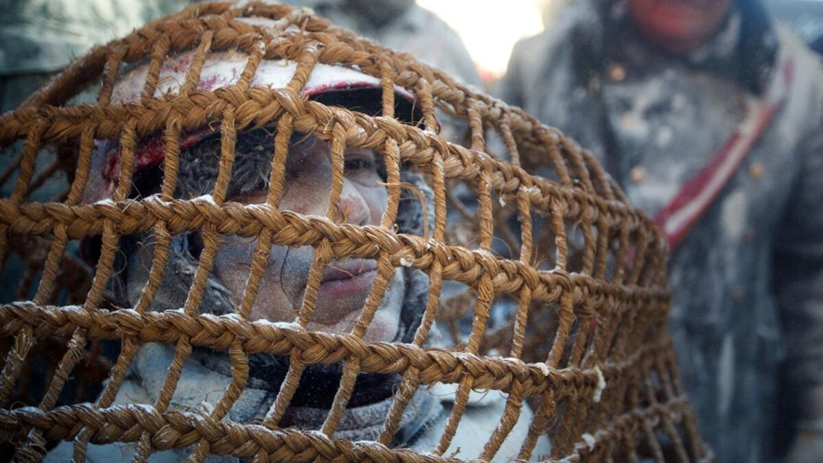 Revellers dressed in mock military garb take part in the "Els Enfarinats" battle in the southeastern Spanish town of Ibi on December 28, 2019. During this 200-year-old traditional festival participants known as Els Enfarinats (those covered in flour) dress in military clothes and stage a mock coup d'etat as they battle using flour, eggs and firecrackers outside the city town hall as part of the celebrations of the Day of the Innocents, a traditional day in Spain for pulling pranks. JAIME REINA / AFP