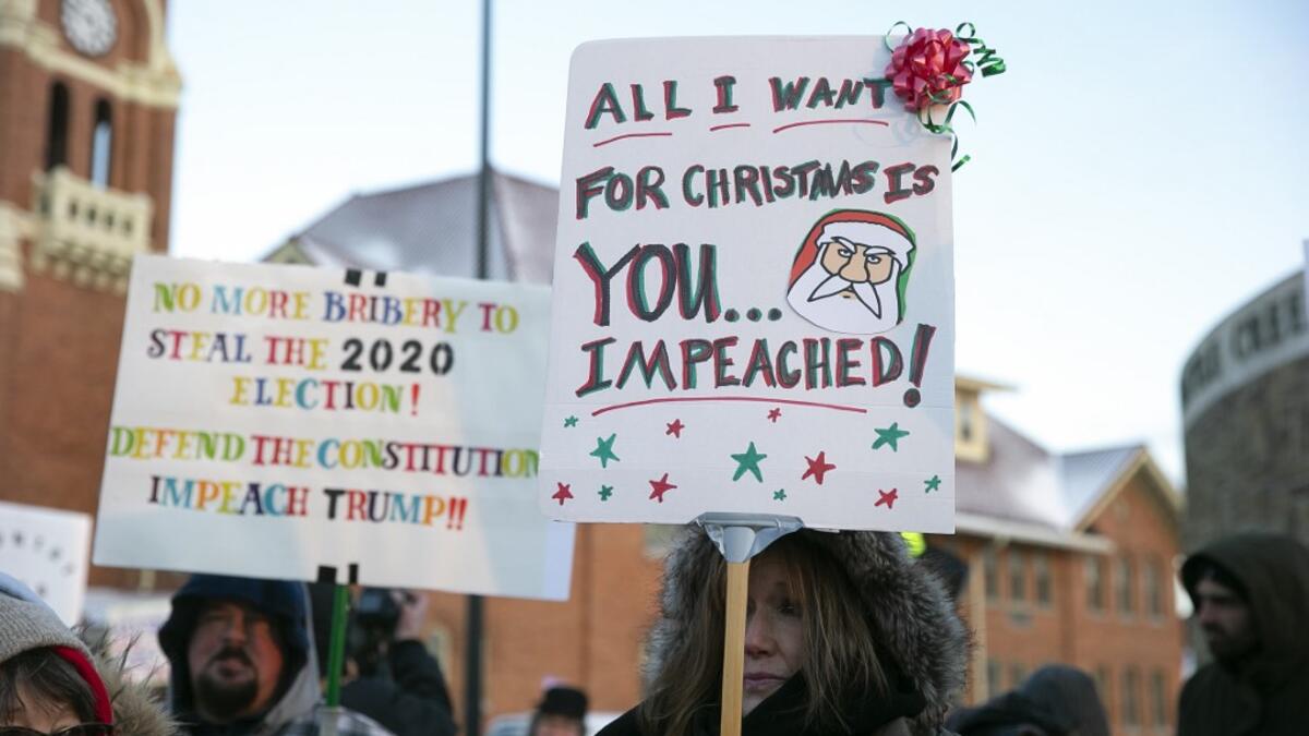 Anti-Trump protesters gather outside at Monument Park on December 18, 2019 in Battle Creek, Michigan. The full House of Representatives is voting on two articles of impeachment against President Donald Trump. Nuccio DiNuzzo/Getty Images/AFP