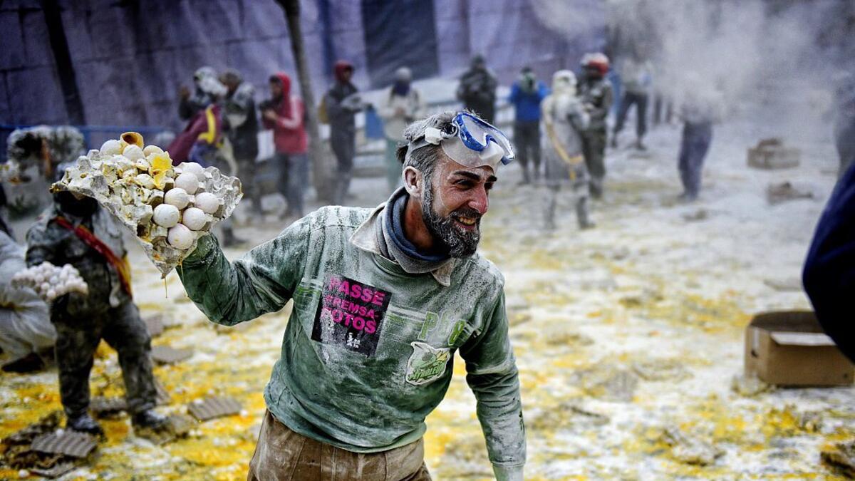 The Els Enfarinats festival takes place every year in Spain and sees two groups of residents cover each other and the entire town white with egg and flour (Twitter)