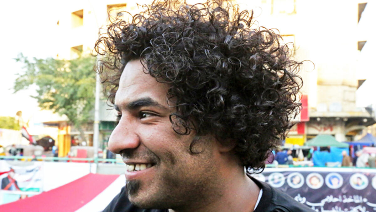 An Iraqi anti-government protestor poses with a distinct hairstyle at Tahrir Square in central Baghdad on December 23, 2019. Since the start of Iraq's anti-government protests on October 1, one thing strikes the eye perhaps above all else -- the unbridled hairstyles young men sport. High quiffs, tight fades and loads of attitude -- it is quite the male beauty pageant. SABAH ARAR / AFP
