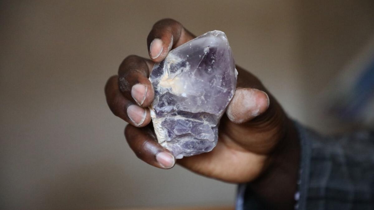 Ayuba Ahmad Muhammed, secretary of the Zamfara State Gold Buyers and Sellers, displays a mined mineral in Gusau, on December 5, 2019. For generations, the mineral-rich earth of Nigeria's Zamfara state has provided families living here with a way to make ends meet. Kola Sulaimon / AFP