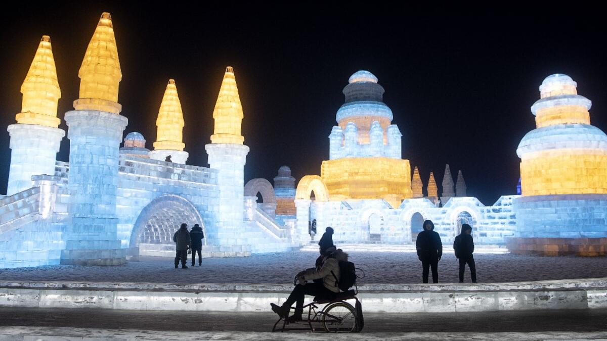 A tourist sits on an ice bike ahead of the opening of the Harbin International Ice and Snow Festival in Harbin, in China's northeast Heilongjiang province on January 3, 2020. NOEL CELIS / AFP
