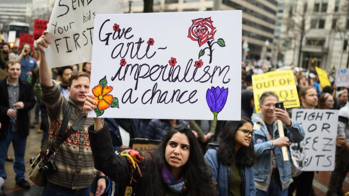 Anti-war activist demonstrate outside the Trump International Hotel in Washington, DC, on January 4, 2020. Demonstrators are protesting the US drone attack which killed Iran's Major General Qasem Soleimani in Iraq on January 3, a dramatic escalation in spiralling tensions between Iran and the US, which pledged to send thousands more troops to the region. ANDREW CABALLERO-REYNOLDS / AFP