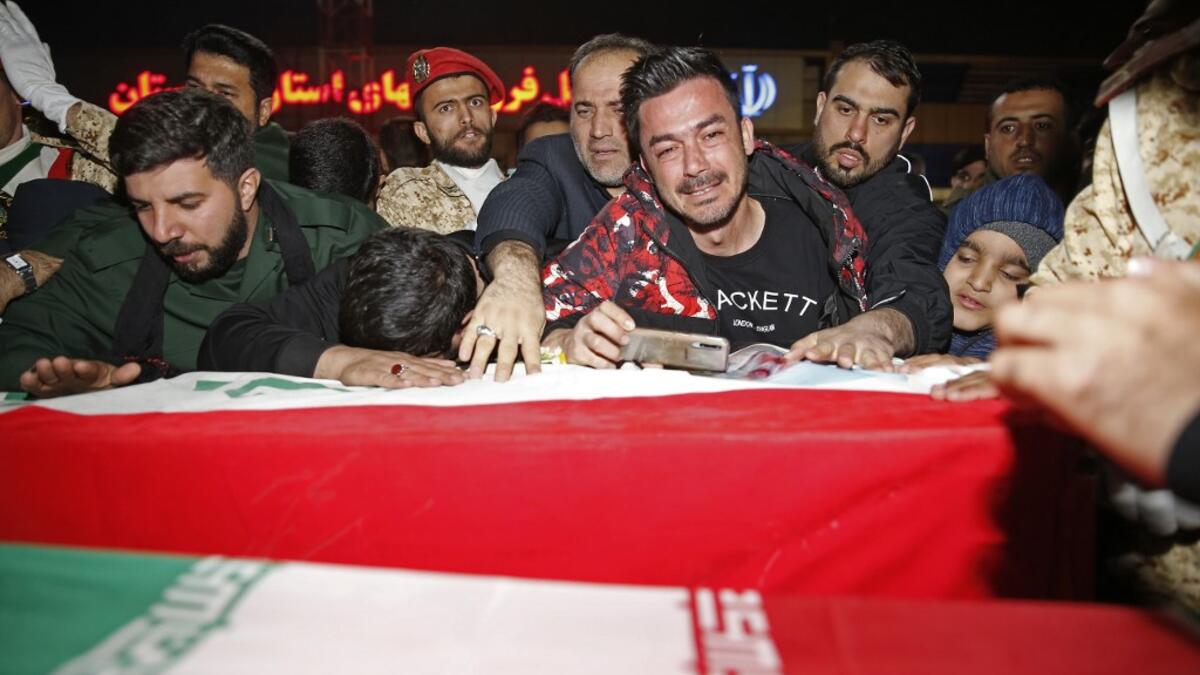 People mourn as they carry the casket of Iranian commander Qasem Soleimani upon arrival at Ahvaz International Airport in Tehran on January 5, 2020. A tide of mourners packed the streets of the Iranian city of Ahvaz Sunday to pay respects to top general Qasem Soleimani, days after he was killed in a US strike. HOSSEIN MERSADI / fars news / AFP