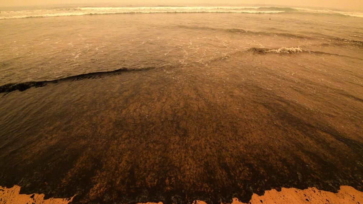 Ash from bushfires washes up on a beach in Merimbula, in Australia's New South Wales state on January 5, 2020. Australians on January 5 counted the cost from a day of catastrophic bushfires that caused "extensive damage" across swathes of the country and took the death toll from the long-running crisis to 24. SAEED KHAN / AFP