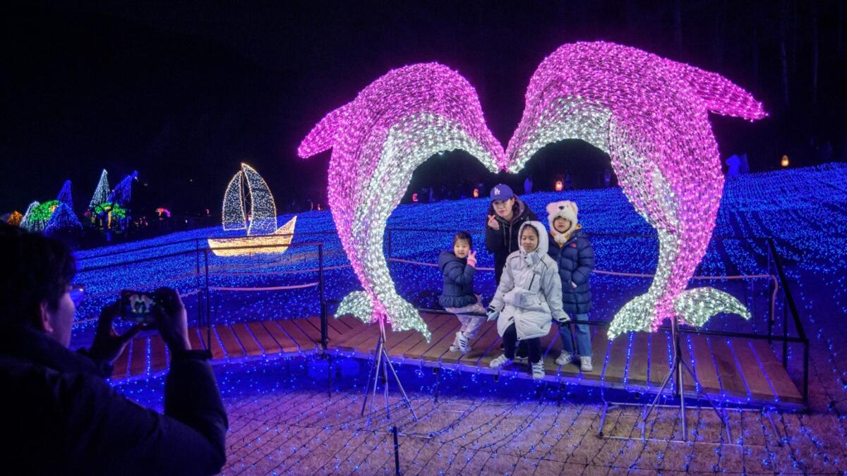 In a photo taken on January 11, 2020 visitors look at an annual light display at the 'Garden on Morning Calm', near Gapyeong, east of Seoul.