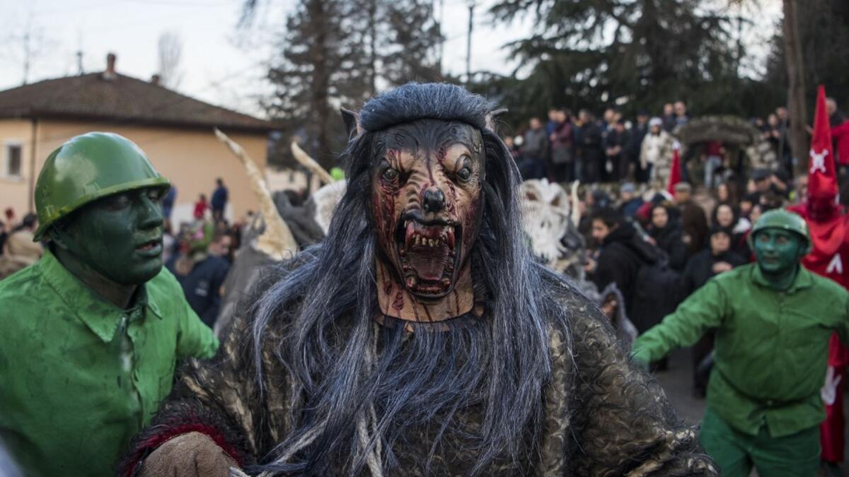 Masked revellers take part in a carnival procession through the south-western North Macedonian village of Vevcani, on January 13, 2020. The Vevcani carnival is 1.400 years old and is held every year on the eve of the feast of Saint Basil (January 14), which also marks the beginning of the New Year according to the Julian calendar, observed by the Macedonian Orthodox Church. Robert ATANASOVSKI / AFP