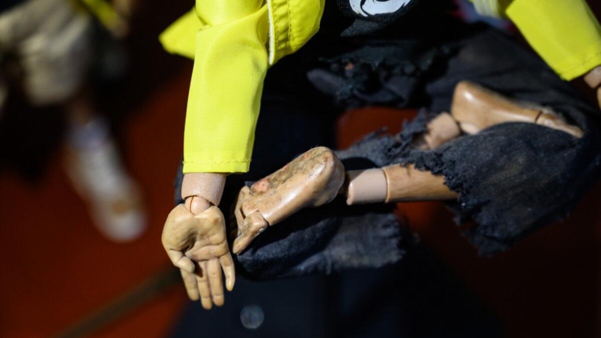 This picture taken on January 14, 2020 shows details of injury scars as part of 1:6 scale action figures depicting characters involved in the Hong Kong protests, in Hong Kong. Intricately detailed Hong Kong protester figurines have become the latest must-have collectables as toy stores recreate the pro-democracy movement's street battles with police in their shop displays.  Philip FONG / AFP