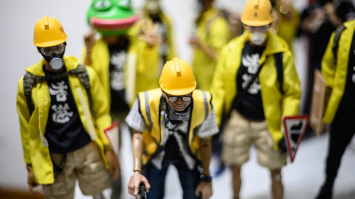 This picture taken on January 14, 2020 shows 1:6 scale action figures depicting characters involved in the Hong Kong protests, in Hong Kong. Intricately detailed Hong Kong protester figurines have become the latest must-have collectables as toy stores recreate the pro-democracy movement's street battles with police in their shop displays.  Philip FONG / AFP