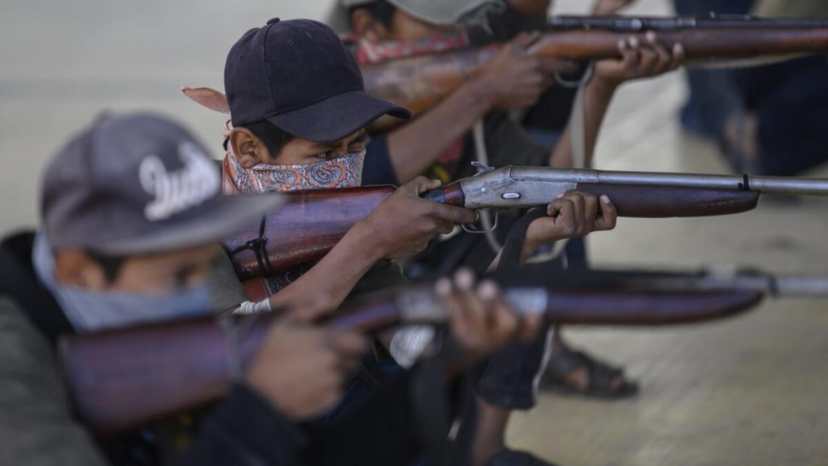 Children are tought to use weapons by the Regional Coordinator of Community Authorities (CRAC-PF) community police force at a basketball court in the village of Ayahualtempan, Guerrero State, Mexico, on January 24, 2020. The CRAC-PF vigilante group trains children as young as five so they can protect themselves from drug-related criminal groups operating in the area. Pedro PARDO / AFP