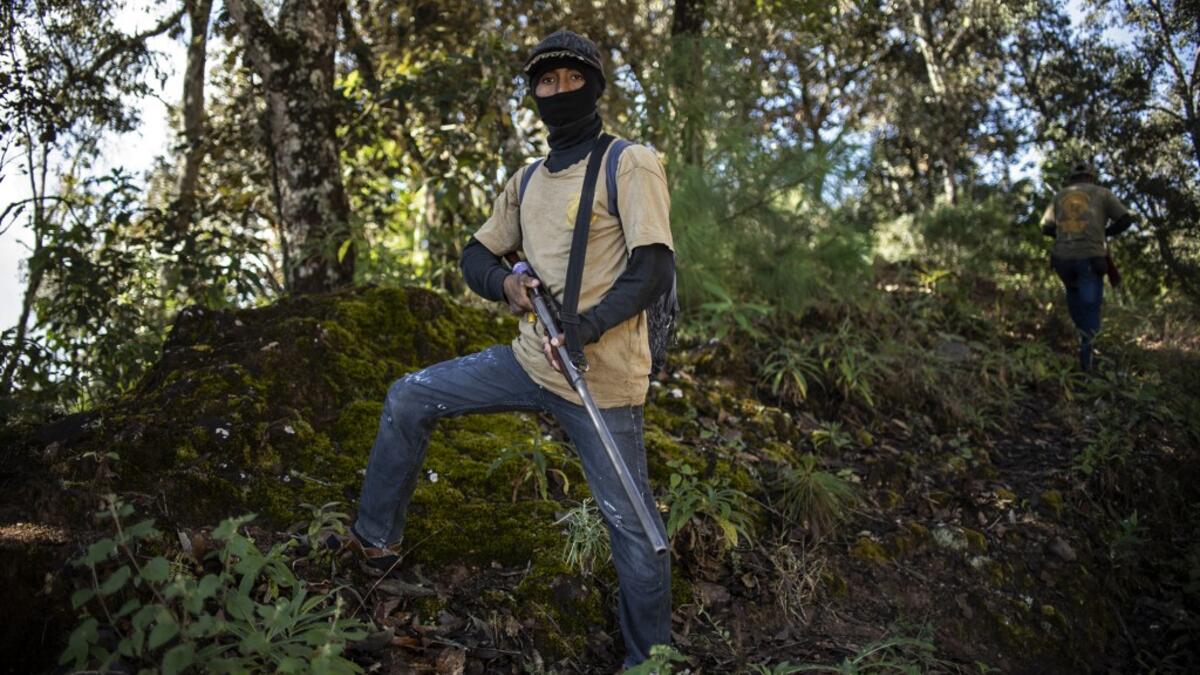 Members of the Regional Coordinator of Community Authorities (CRAC-PF) community police force patrol the village of Ayahualtempan, Guerrero State, Mexico, on January 24, 2020. The CRAC-PF vigilante group trains children as young as five so they can protect themselves from drug-related criminal groups operating in the area. Pedro PARDO / AFP