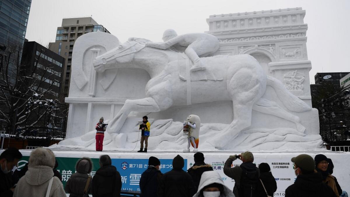 The snow festival, which opened January 31 in the capital of Hokkaido in northern Japan, is a major draw for the region, attracting more than 2.7 million visitors last year. Organisers for this year's festival were forced to truck in an unprecedented amount of extra powder to build their signature sculptures after an unseasonably warm winter.  CHARLY TRIBALLEAU / AFP