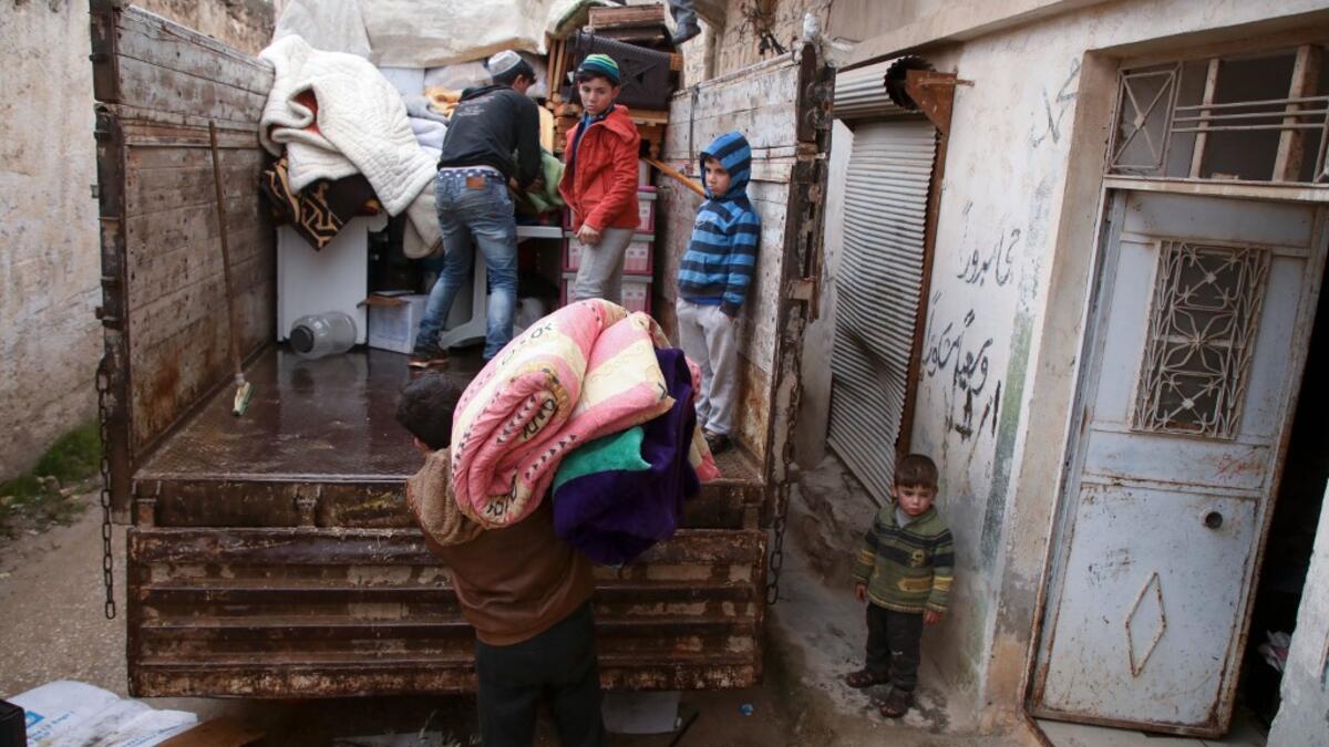Syrians load their belongings onto a truck as they prepare to leave the town of Binnish in the northwestern province of Idlib, on February 4, 2020, amid an ongoing offensive by pro-regime forces. A Russian-backed Syrian government offensive against the country's last rebel enclave of Idlib has displaced more than half a million people in two months, according to the United Nations. The wave of displacement, which coincides with a biting winter, is one of the largest since the start of the Syrian war nearly