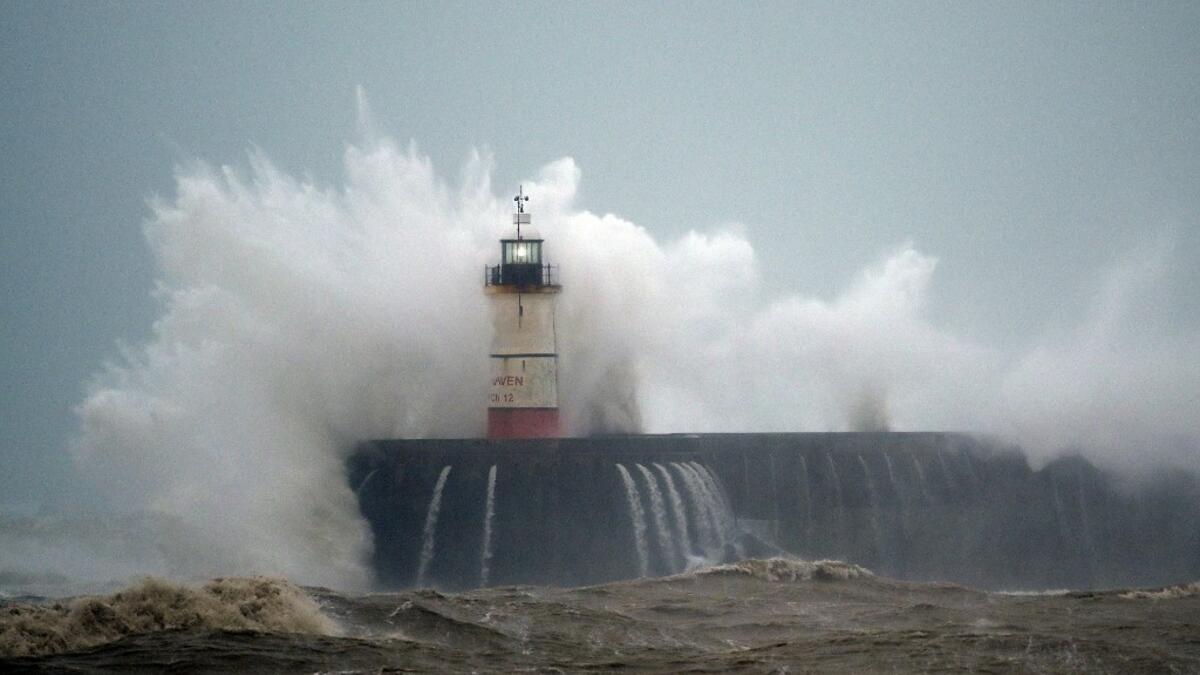 Waves crash over Newhaven Lighthouse on the south coast of England on February 9, 2020, as Storm Ciara swept over the country. GLYN KIRK / AFP