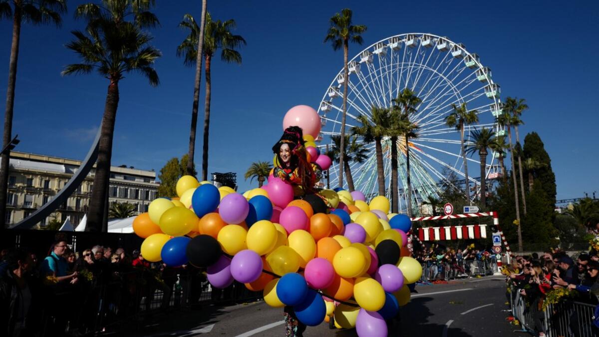 A participant in fancy dress takes part in the 136th Nice Carnival parade which celebrates this year the 'Fashion King' in Nice, southeastern France, on February 15, 2020. The carnival runs from February 15 to February 29, 2020. VALERY HACHE / AFP