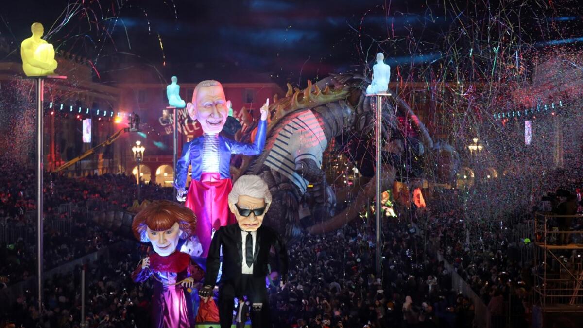 Giant figures depicting German fashion designer Karl Lagerfeld (R), and French fashion designers Sonia Rykiel (L) and Jean-Paul Gaultier are seen during the 136th Nice Carnival parade in Nice, southeastern France, on February 15, 2020. The Carnival takes place until February 29, 2020 on the theme 'King of Fashion'. VALERY HACHE / AFP