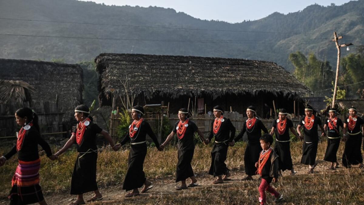 This photo taken on February 7, 2020 shows the end of an overnight ceremony to bless the harvest by Naga tribeswomen in Satpalaw Shaung village, Lahe township in Myanmar's Sagaing region. A haunting refrain pierces the night as the tribeswomen of the Gongwang Bonyo, among the most isolated people in Myanmar, dance around a campfire to bless the harvest ahead. Ye Aung THU / AFP