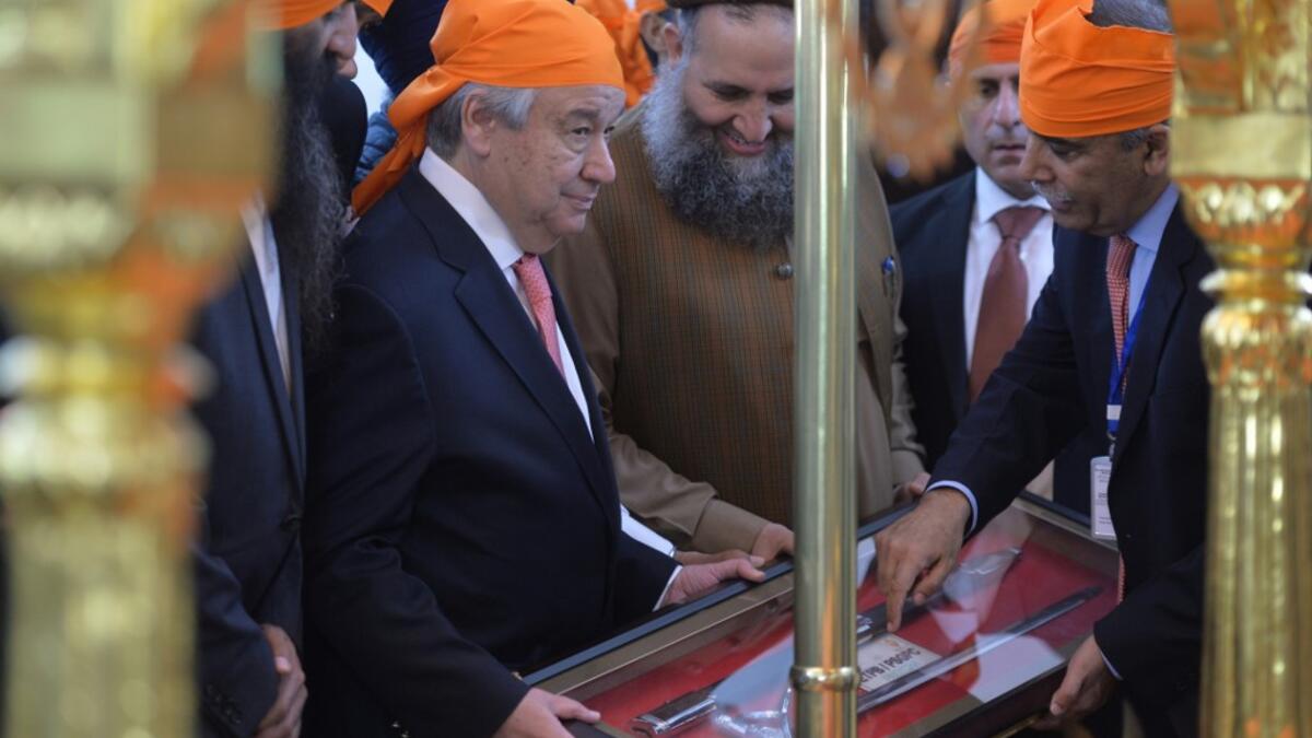 United Nations Secretary-General Antonio Guterres (L) receives a souvenir from Shrine officials during his visit to the Sikh Shrine of Baba Guru Nanak Dev at Gurdwara Darbar Sahib in the Pakistani town of Kartarpur, near the Indian border, on February 18, 2020. Aamir QURESHI / AFP
