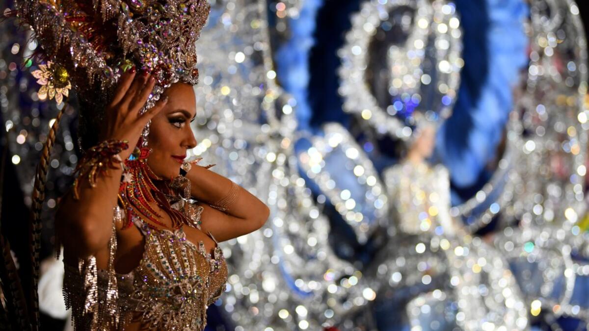 A participant prepares backstage before presenting her outfit during the Queen of the Carnival pageant contest in Santa Cruz de Tenerife, on the Spanish Canary island of Tenerife, on February 19, 2020. Gabriel BOUYS / AFP