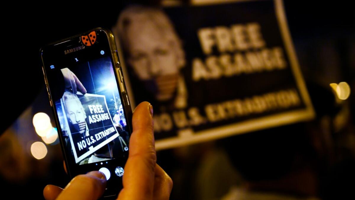 A demonstrator takes a picture with a smartphone during a protest called by Catalan National Assembly (ANC) under the motto "Journalism is not a crime" to support WikiLeaks founder Julian Assange in Barcelona on February 24, 2020. A British court today starts hearing Washington's extradition request for WikiLeaks founder Julian Assange in a test case of media freedoms in the digital age and the global limits of US justice. LLUIS GENE / AFP