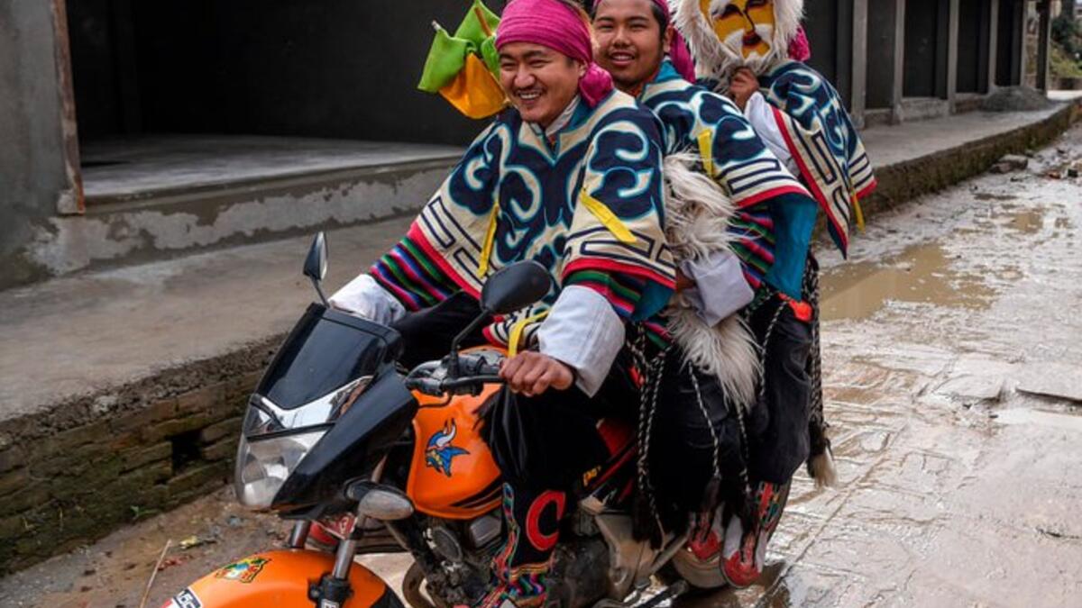 Tibetan in exile performers arrive on a motorbike before performing at the Boudhanath Stupa area during celebrations marking the third day of the Lhosar Tibetan New Year in Kathmandu (Twitter)