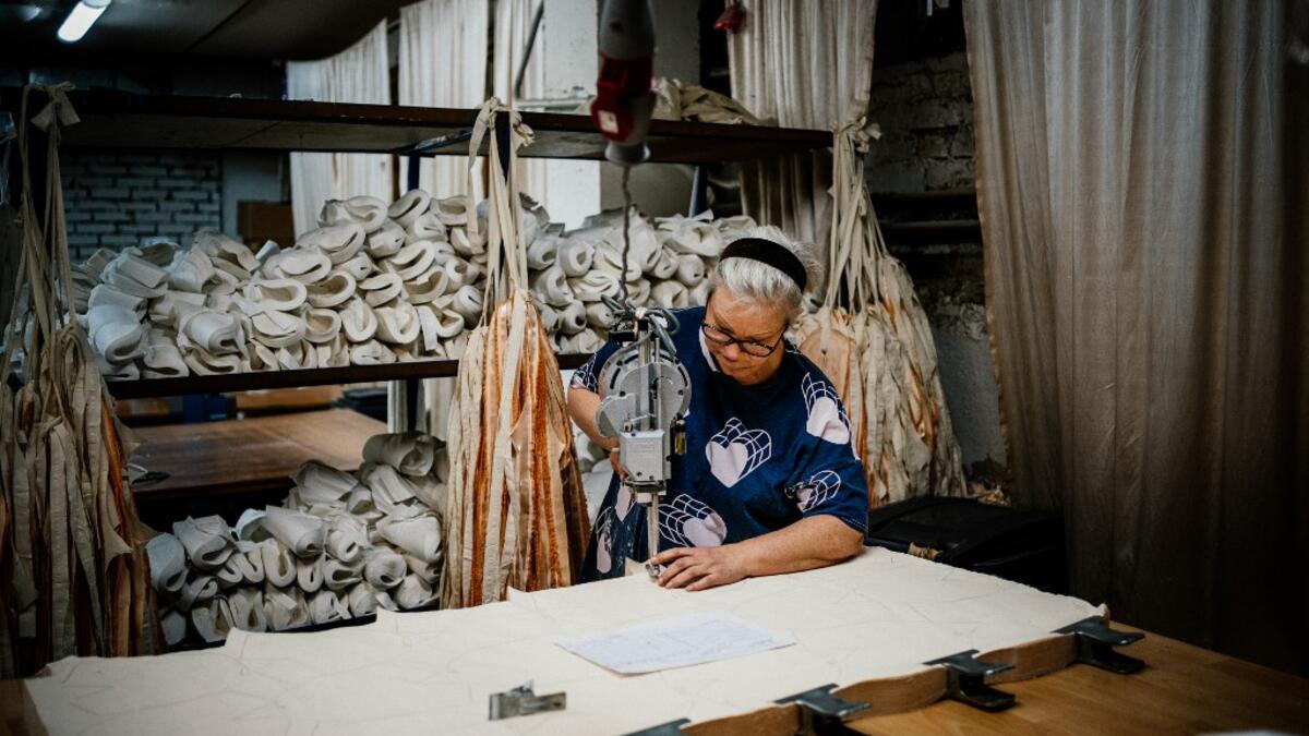 An employees of Grishko company produces pointe shoes in the company's Moscow workshop on February 25, 2020. Born in the chaos of the collapse of the Soviet Union, the Grishko family business has emerged among the top makers in the world of dance shoes, notably classic ballet pointe shoes, worn on the world's great stages. Dimitar DILKOFF / AFP
