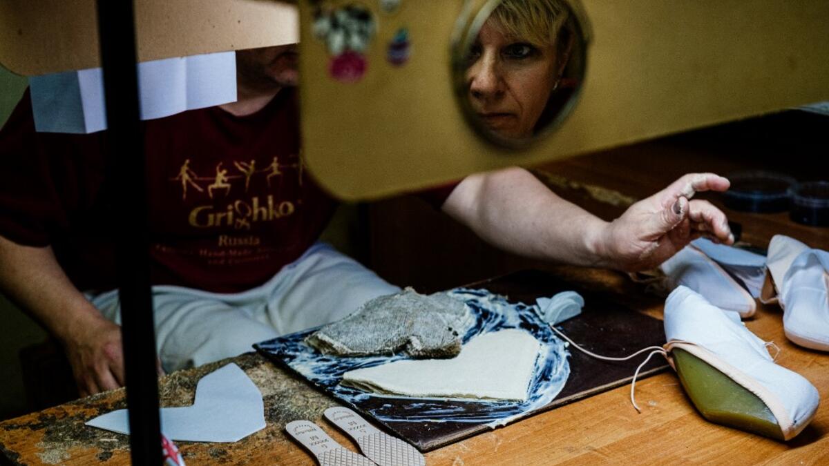 An employees of Grishko company produces pointe shoes in the company's Moscow workshop on February 25, 2020. Born in the chaos of the collapse of the Soviet Union, the Grishko family business has emerged among the top makers in the world of dance shoes, notably classic ballet pointe shoes, worn on the world's great stages. Dimitar DILKOFF / AFP