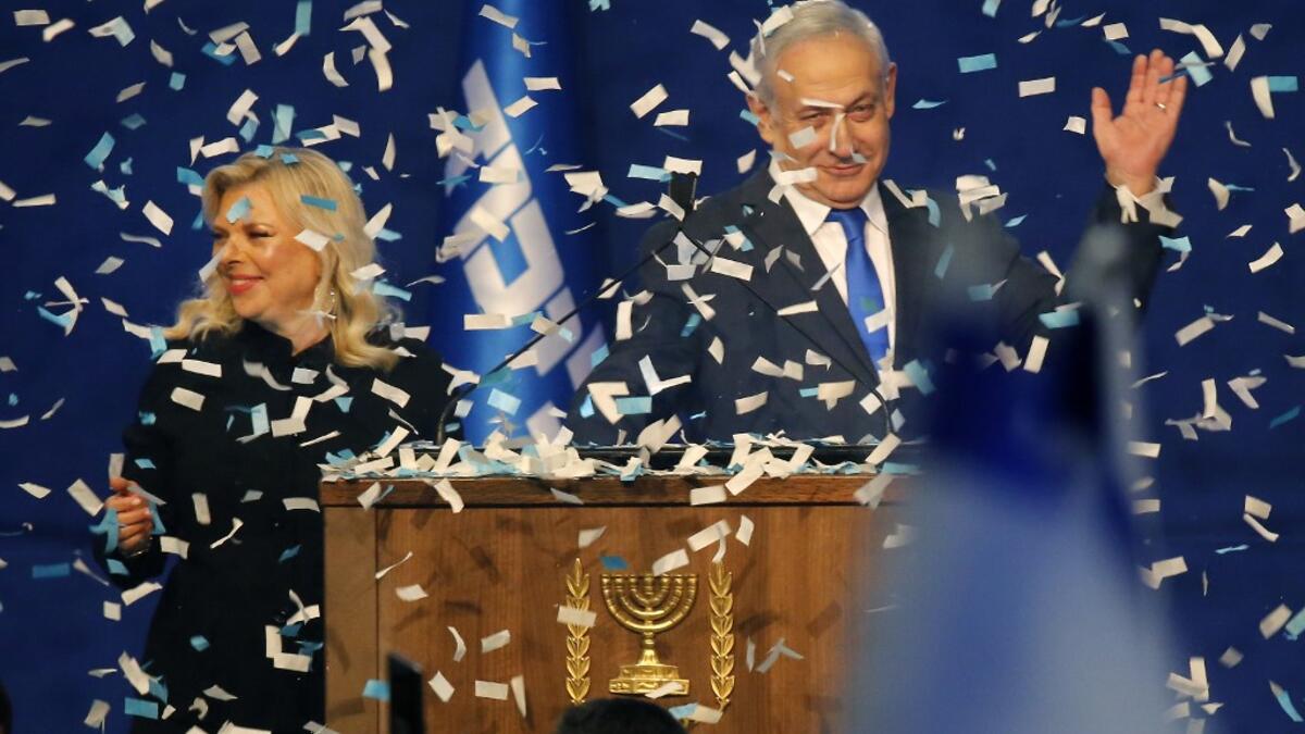 Israeli Prime Minister Benjamin Netanyahu and his wife Sara address supporters as confetti falls upon them at the Likud party campaign headquarters in the coastal city of Tel Aviv early on March 3, 2020, after polls officially closed. Netanyahu claimed "a giant victory" in elections on March 3, boasting that his right-wing Likud party had defied "all expectations" in the country's third vote in less than a year. After exit polls by three networks forecast that Likud and its allies were on track to win 59 pa