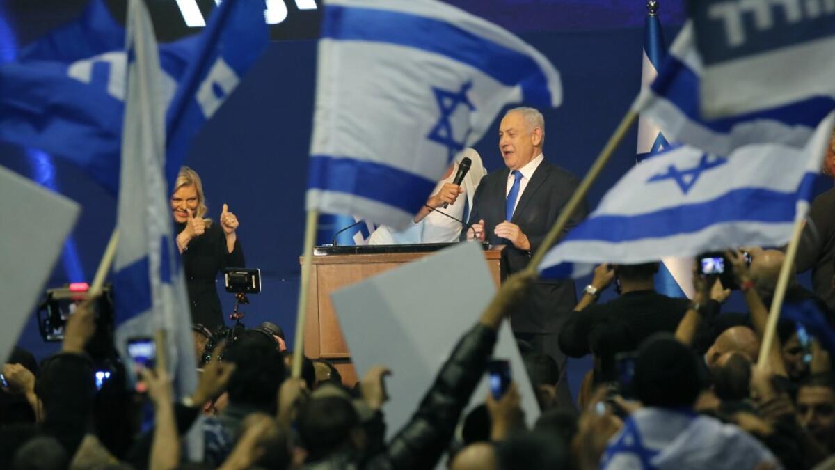 Israeli Prime Minister Benjamin Netanyahu and his wife Sara address supporters at the Likud party campaign headquarters in the coastal city of Tel Aviv early on March 3, 2020, after polls officially closed. Netanyahu claimed "a giant victory" in elections on March 3, boasting that his right-wing Likud party had defied "all expectations" in the country's third vote in less than a year. After exit polls by three networks forecast that Likud and its allies were on track to win 59 parliamentary seats -- two sho