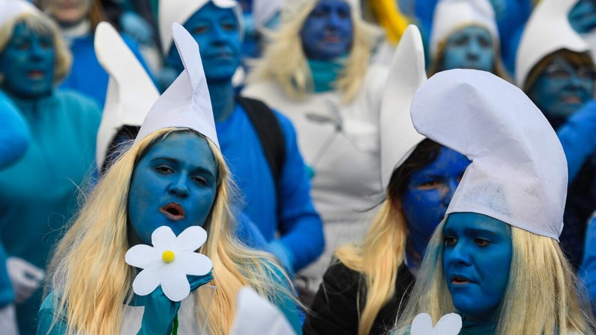 People dressed as Smurfs ('Schtroumpfs' in French), a Belgian comic franchise centered on a fictional colony of small, blue, human-like creatures who live in mushroom-shaped houses in the forest, attend a world record gathering of Smurfs on March 7, 2020, in Landerneau, western France. Damien MEYER / AFP