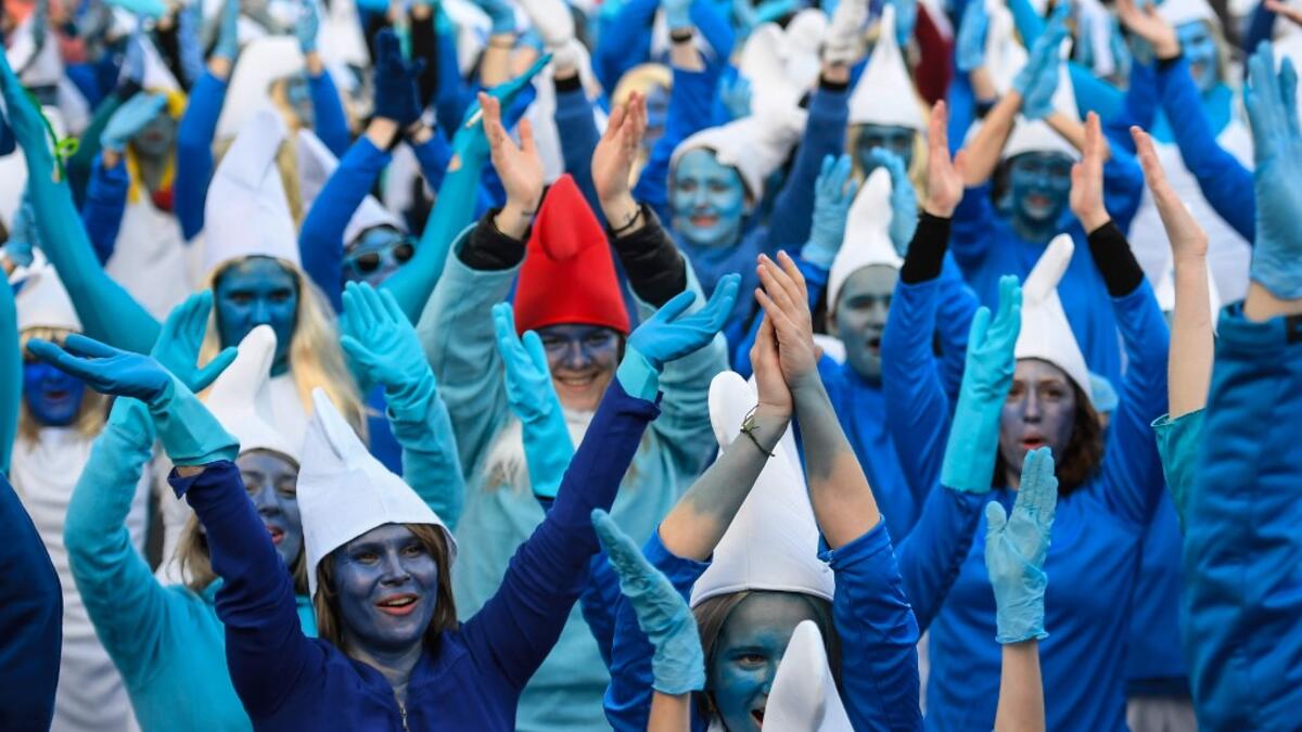People dressed as Smurfs ('Schtroumpfs' in French), a Belgian comic franchise centered on a fictional colony of small, blue, human-like creatures who live in mushroom-shaped houses in the forest, attend a world record gathering of Smurfs on March 7, 2020, in Landerneau, western France. Damien MEYER / AFP