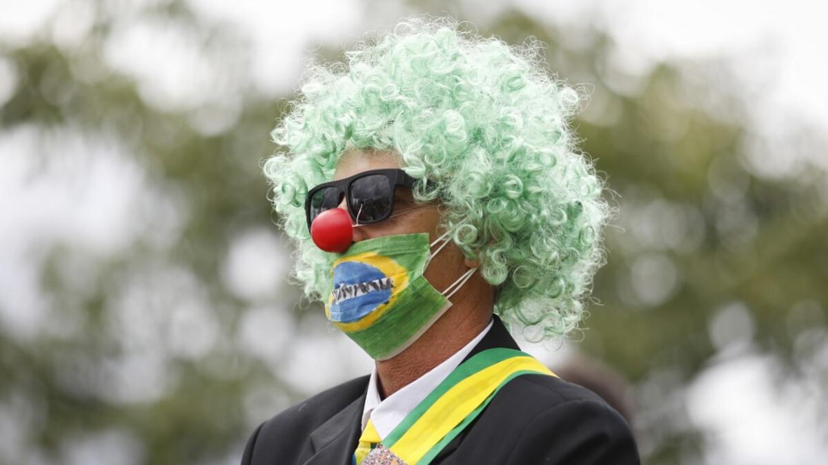 A supporter of the Brazilian President Jair Bolsonaro takes part in a protest against the National Congress and the Supreme Court while wearing a protective face mask to prevent the spread of the new Coronavirus, COVID-19, in Brasilia, on March 15, 2020. Sergio LIMA / AFP