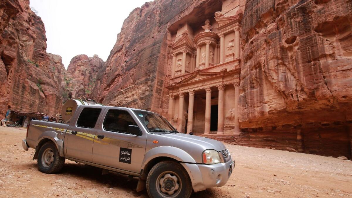 A labourer sprays disinfectant in Jordan's archaeological city of Petra south of the capital Amman on March 17, 2020, to prevent the spread of COVID-19. Khalil MAZRAAWI / afp