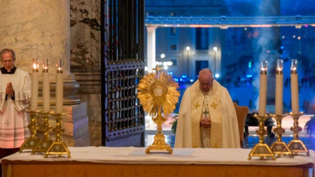 Pope Francis prepares to give the Urbi et orbi blessing after presiding over a moment of prayer on the sagrato of St Peter's Basilica, the platform at the top of the steps immediately in front of the facade of the church. (Photo: Vatican Media/AFP via Getty Images)