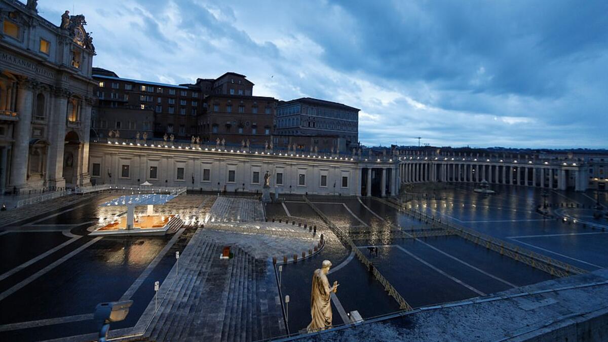 An aerial view of the Pope outside the Vatican, Rome giving the unusual 'Urbi et Orbi' blessing. He can seen here on an illuminated sheltered podium outside the entrance to the Vatican but St Peter's Square remained deserted due to lockdown. (AFP/File)