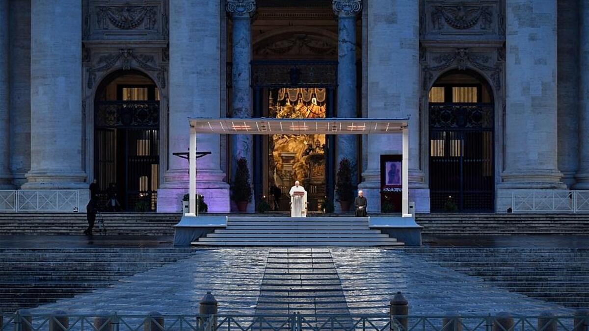 Pope Francis presided over a moment of prayer on the sagrato, accompanied only by one other priest and television crews broadcasting his message to Italy and the rest of the world. (AFP/File)