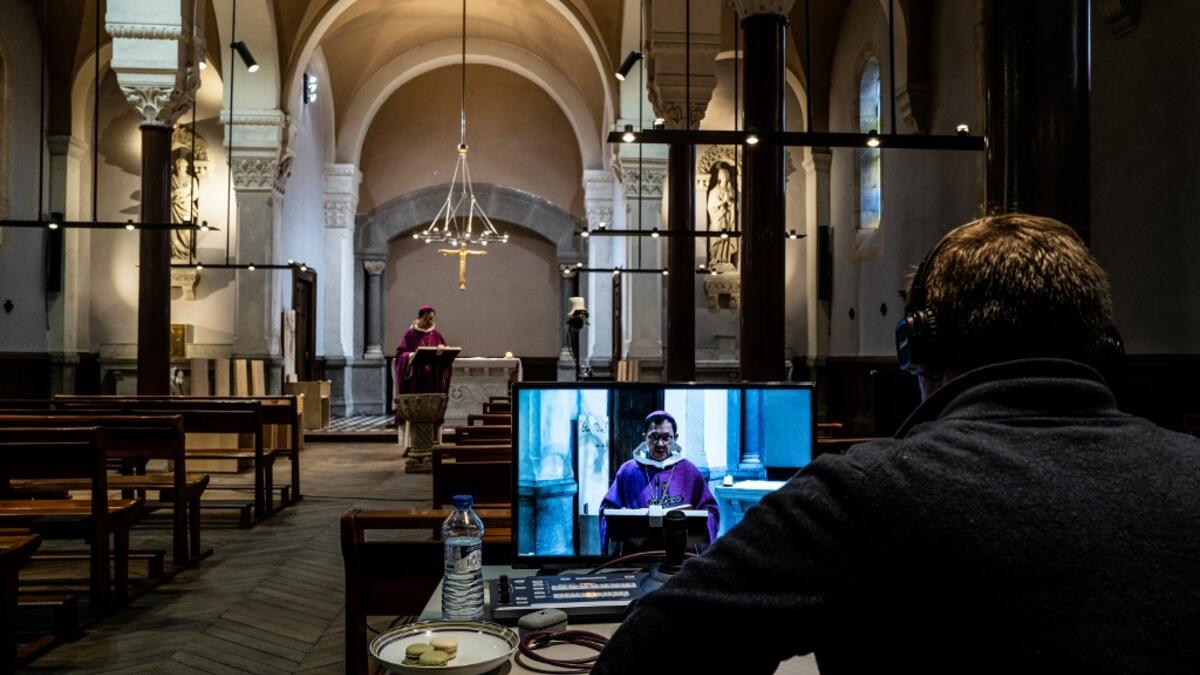 Auxiliary bishop of Lyon Emmanuel Gobilliard holds a streamed live Mass in the empty Saint-Irenee church, in Lyon, on March 24, 2020, on the eighth day of a lockdown aimed at curbing the spread of the virus. JEFF PACHOUD / AFP