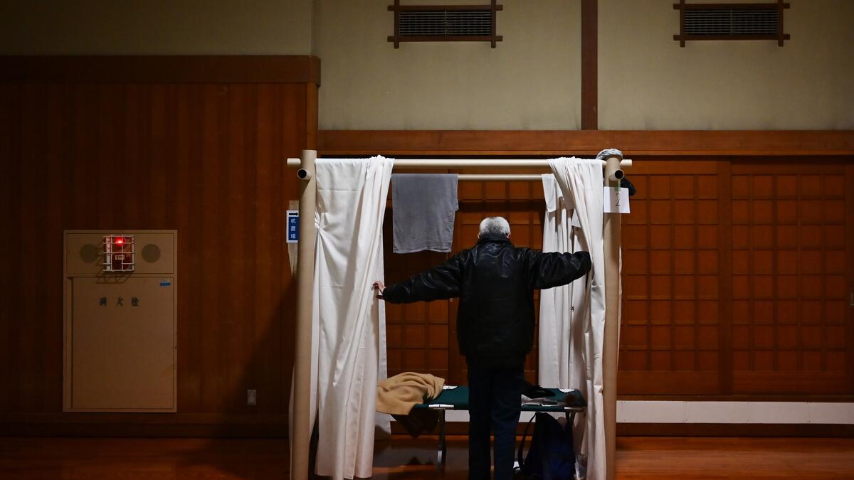 Katsuya Asao, 54, prepares to rest at a shelter provided by Kanagawa prefecture for the people who can’t afford to rent an apartment and used to stay at designated internet cafes, which are closed due to the COVID-19 coronavirus outbreak state of emergency, at a Judo sport hall in Yokohama, Kanagawa prefecture on April 13, 2020. CHARLY TRIBALLEAU / AFP